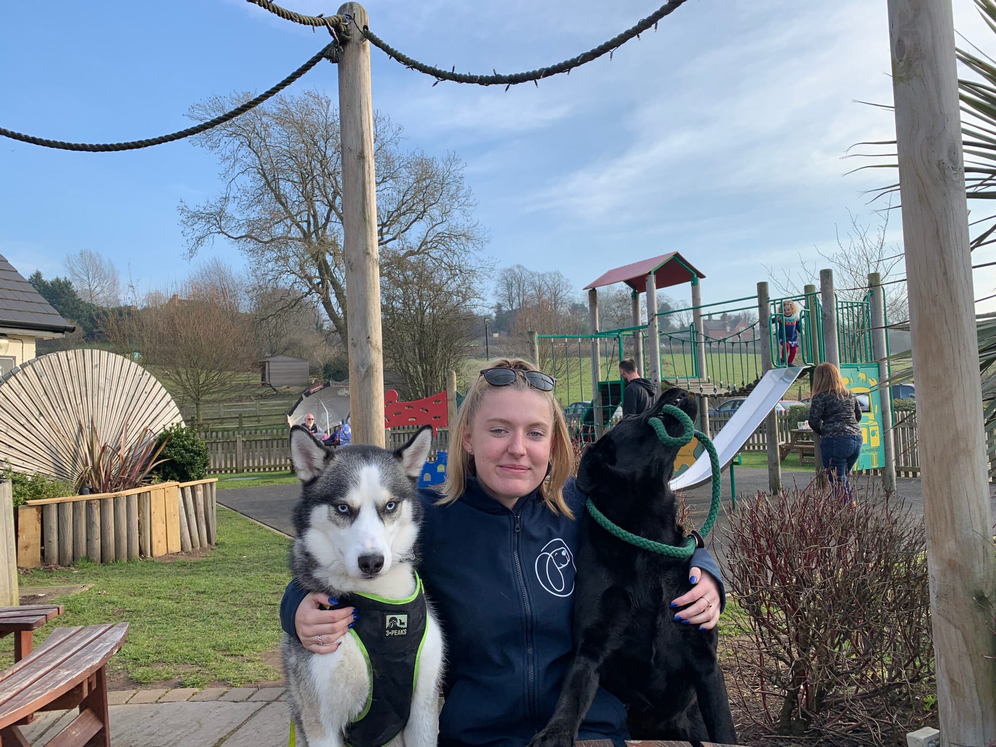 Joanne Lenham of PawMates with a husky and a black labrador
